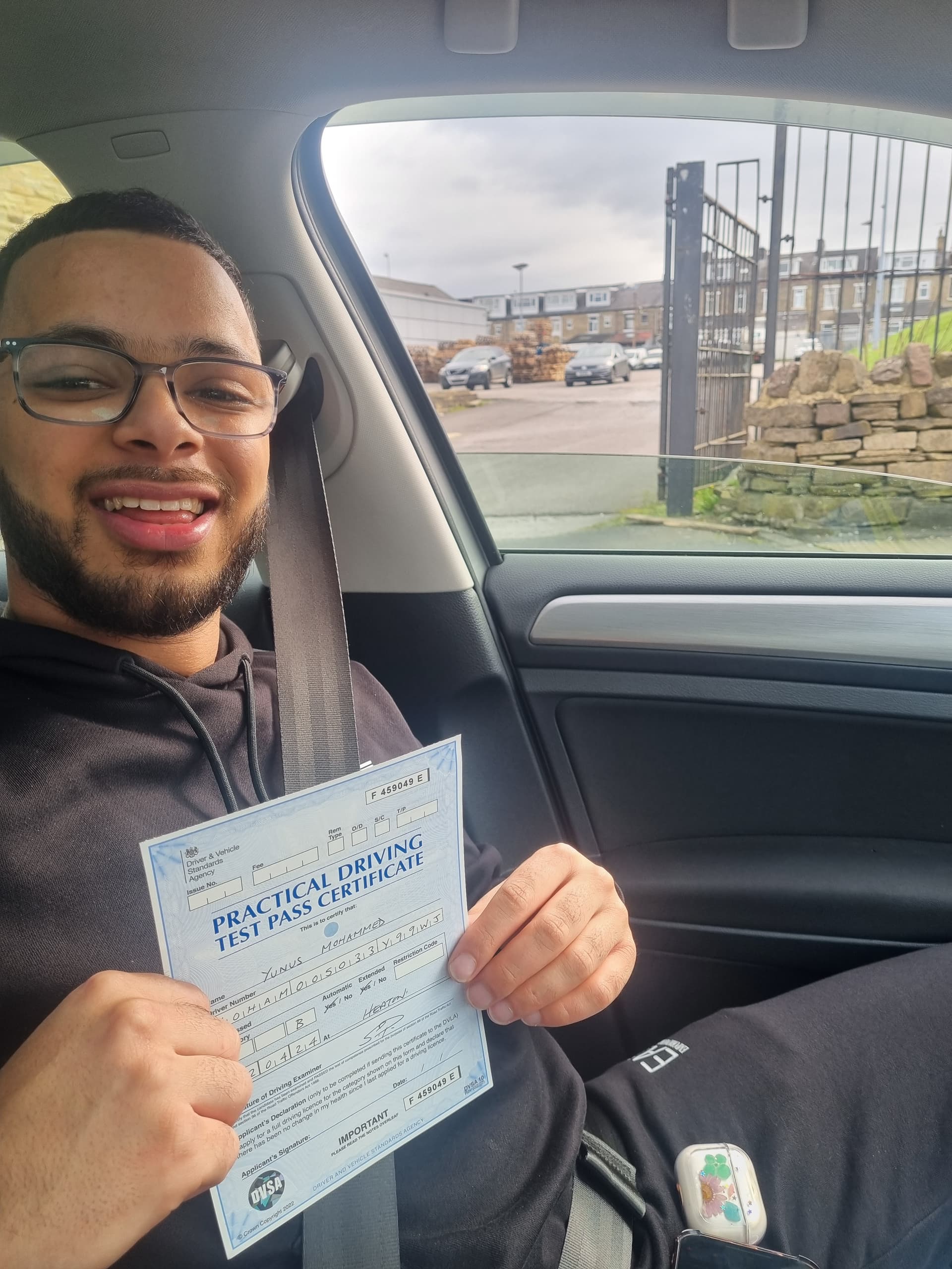Learner holding driving test pass certificate in Leeds